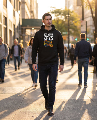 Not Your Keys on a black hoodie, city street, golden hour